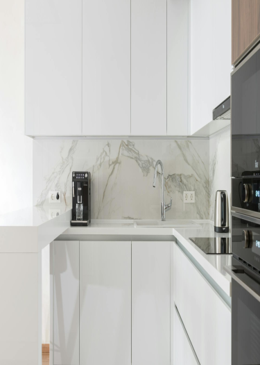 image of Glossy White Aluminum Kitchen With Natural Marble Countertops