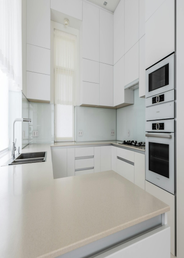 image of White Aluminum Kitchen With Natural Marble Countertops